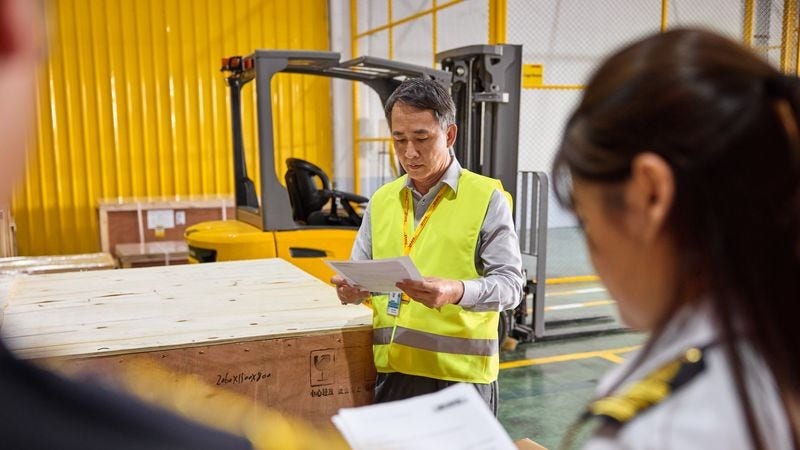 customs officer and employee cross-check an air waybill