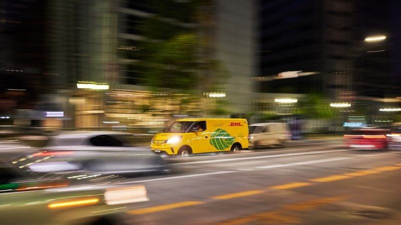DHL Express employee on the way to deliver return shipment to a business in Indonesia