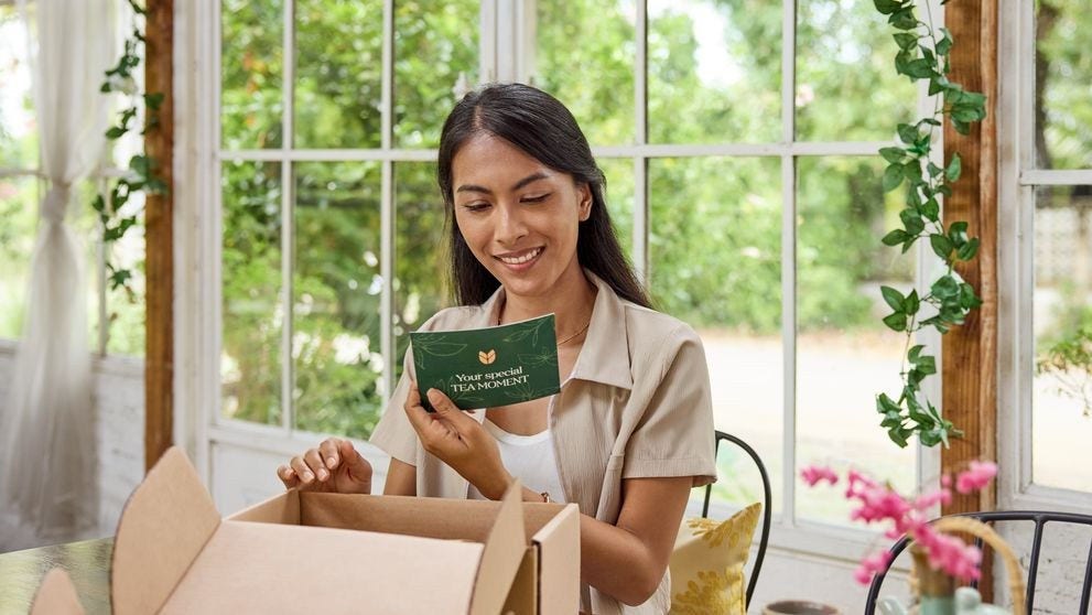 customer reading her personalised card from purchase