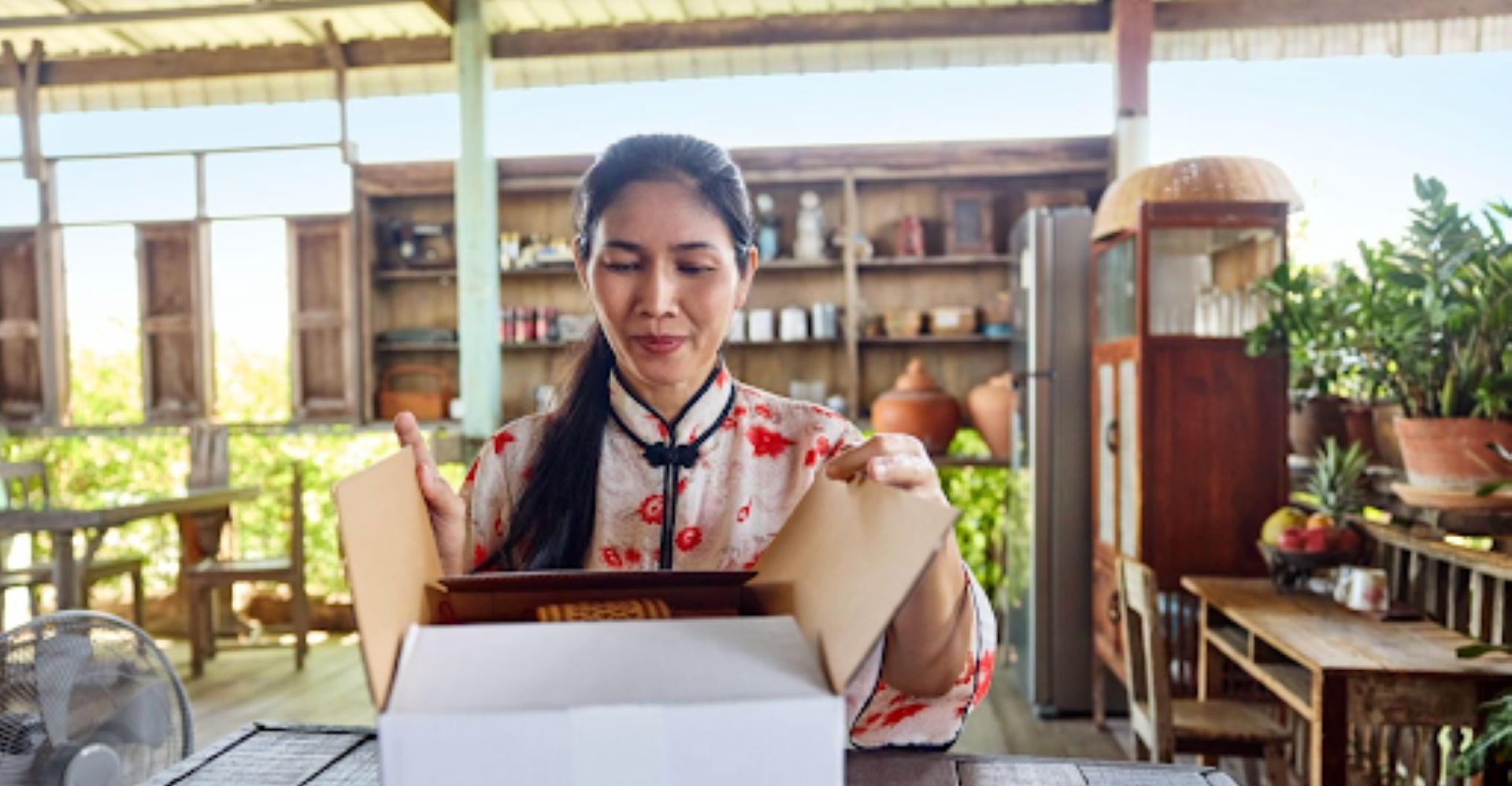 Vietnamese woman opens her DHL Express parcel