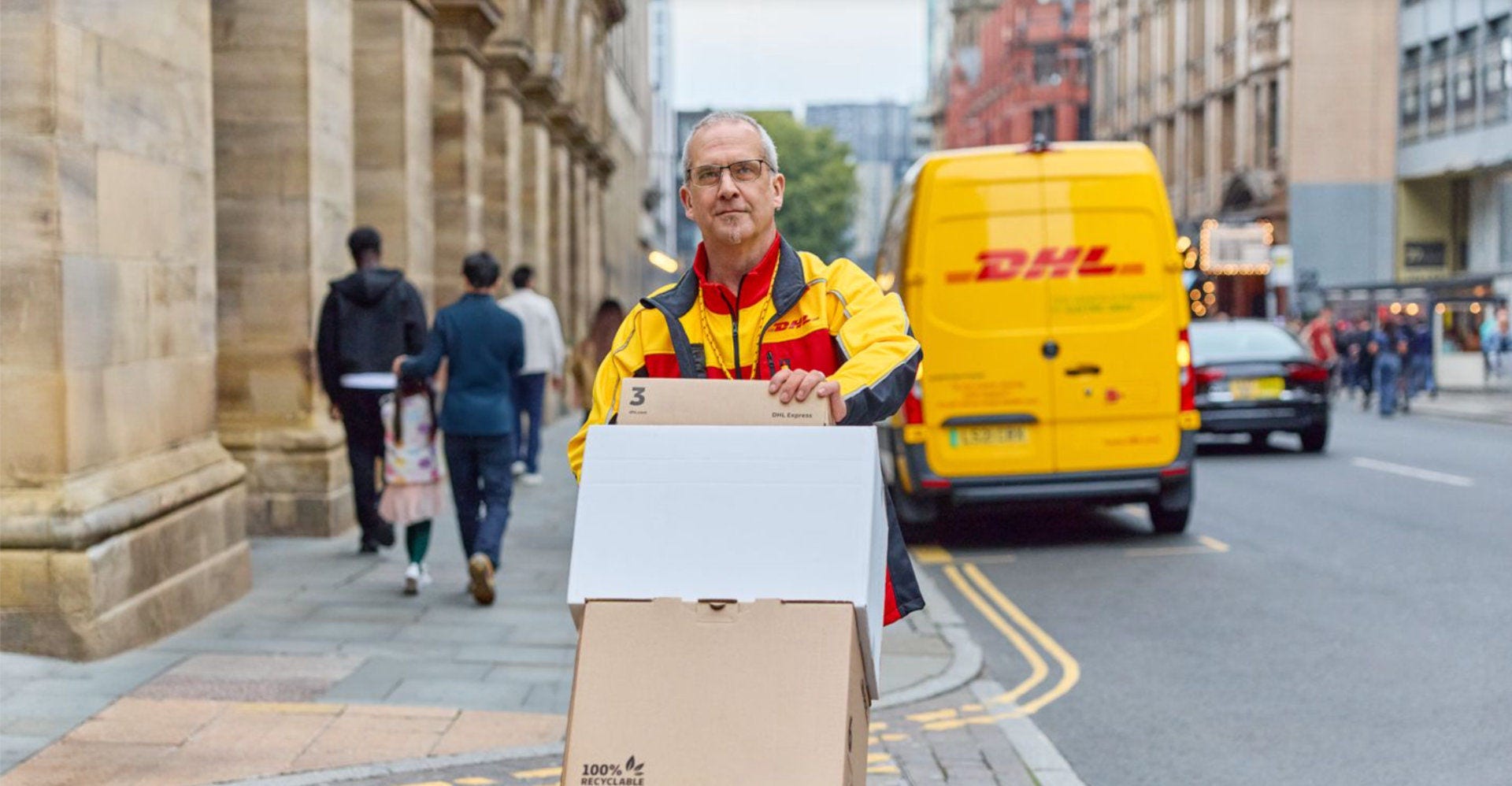 DHL Express employee delivering various packages