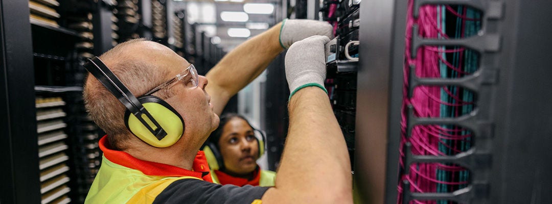 Man wearing headphones in a server room