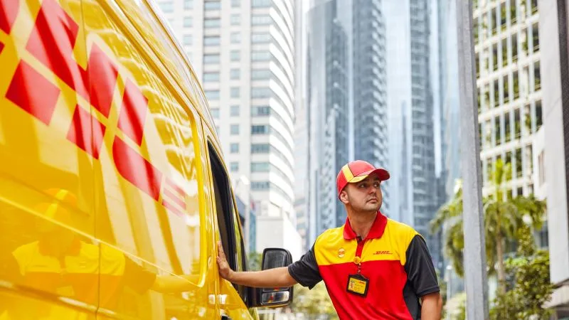 dhl express employee delivering in the city to ensure route optimization in logistics