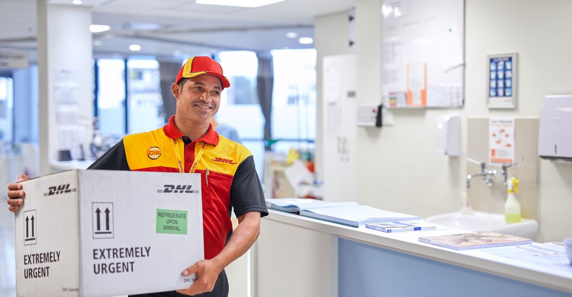 dhl employee delivering a package at to a medical centre 