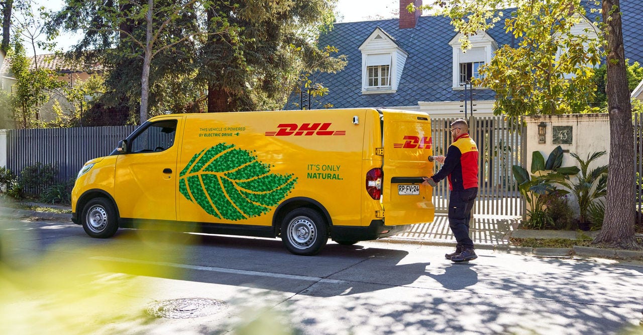 dhl electric delivery van with eco-friendly branding, parked in a residential area
