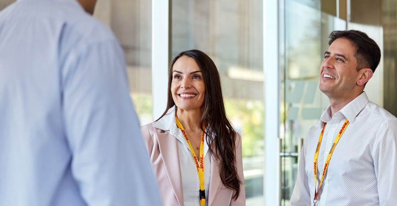 DHL employees having a conversation in the office