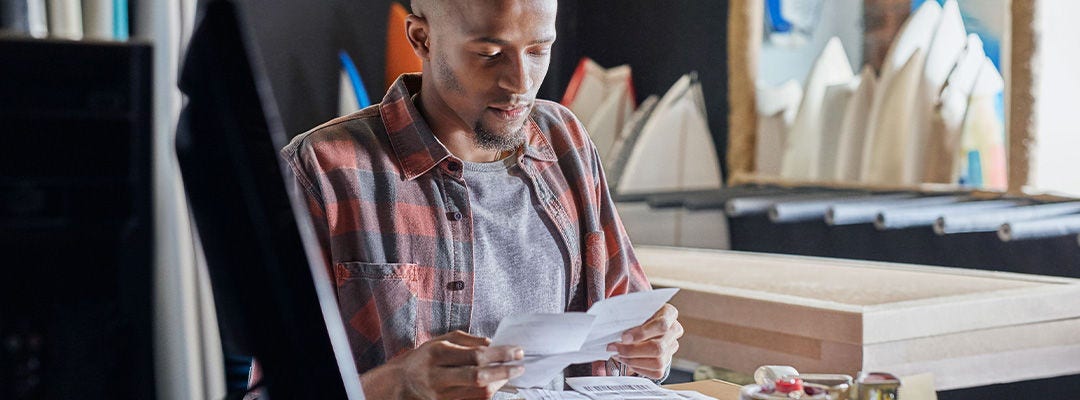 man looking at a paper