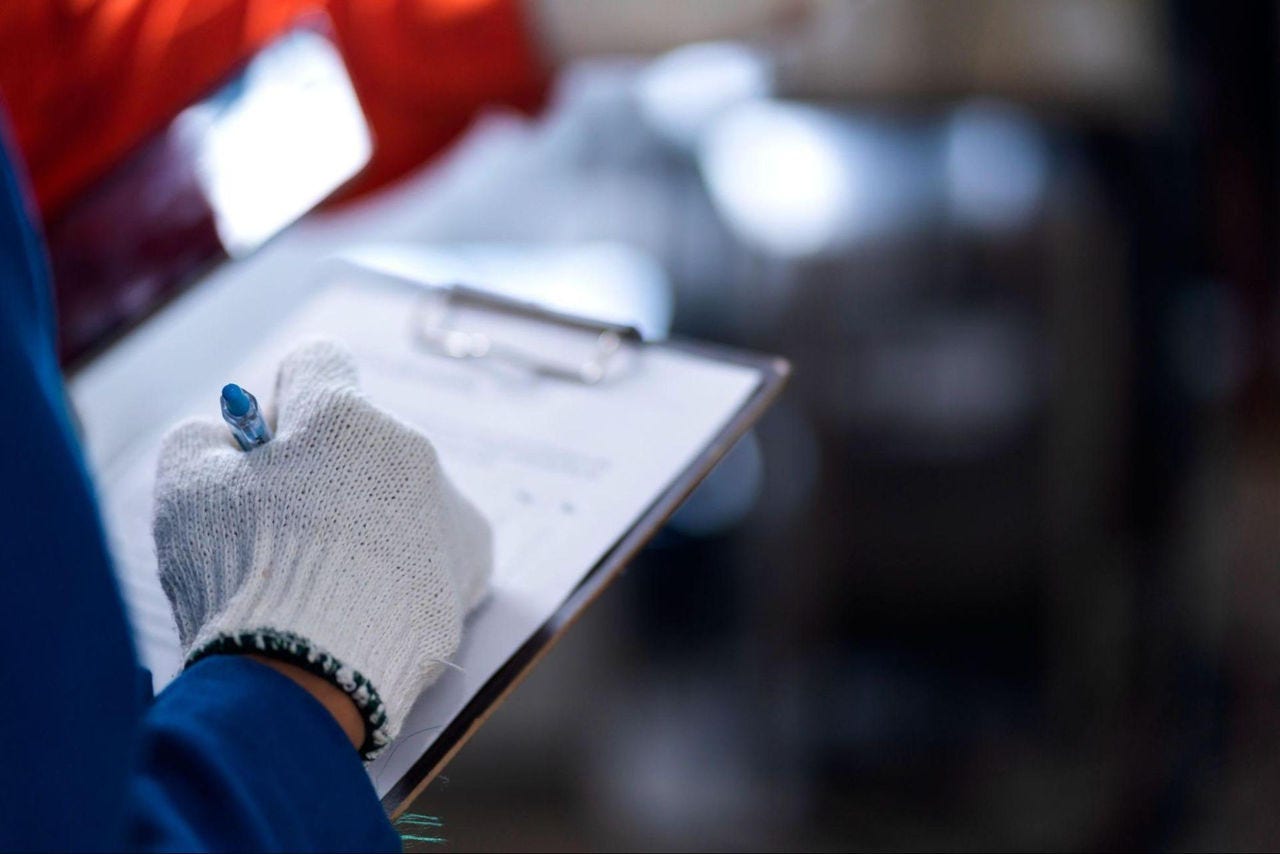 logistics employee marking a checklist
