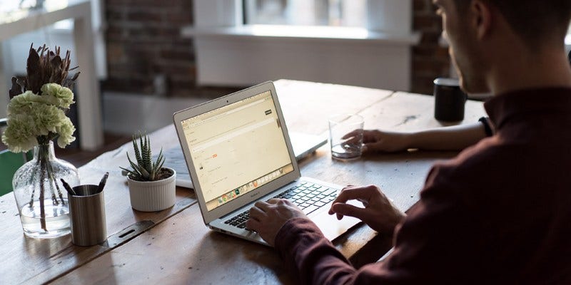 Man typing and working on a laptop