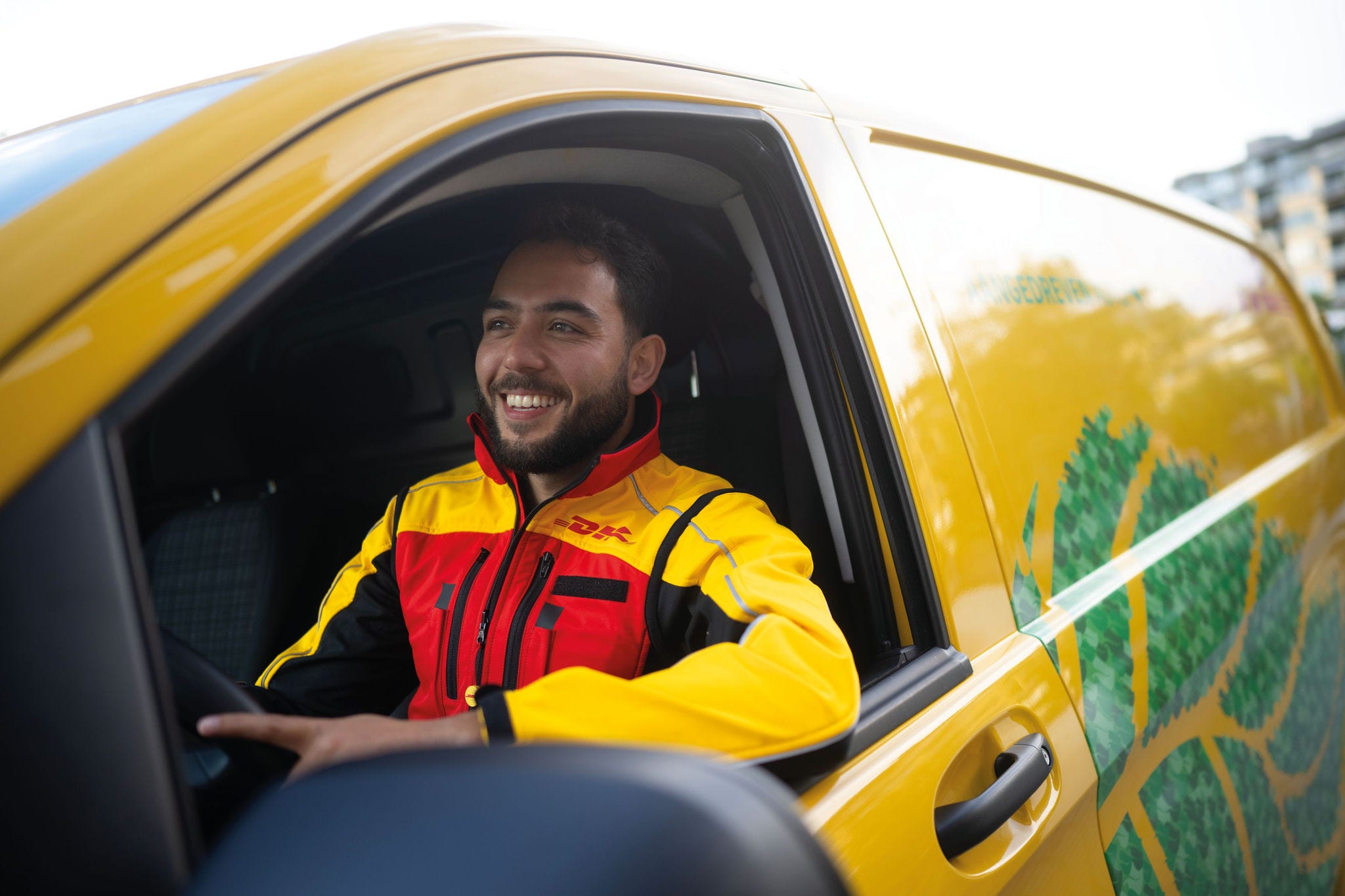 dhl express courier driving a delivery van