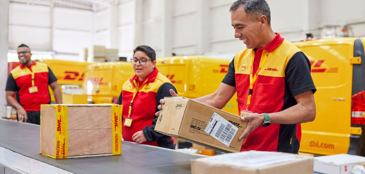 three DHL employees loading packages