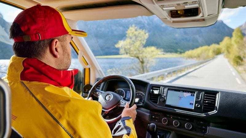 DHL employee driving a delivery van to deliver parcels