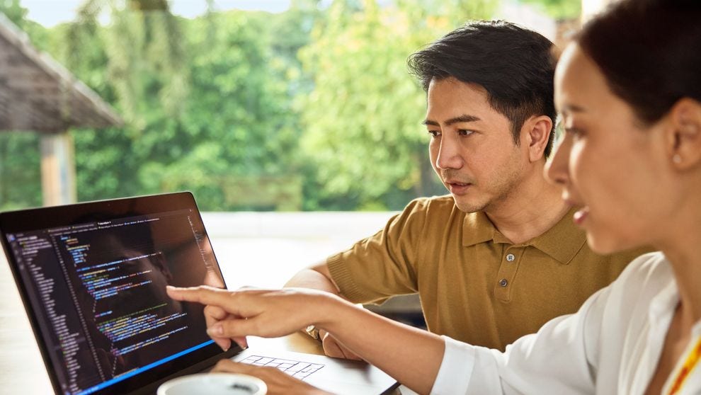 chinese business owner discussing website with partner