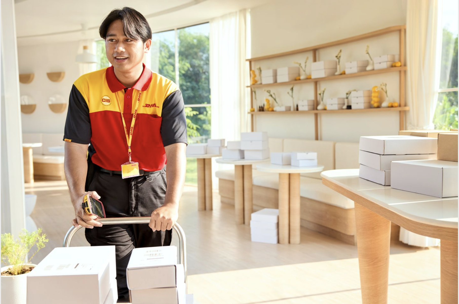 A DHL Express employee picking up parcels at a sustainable shop