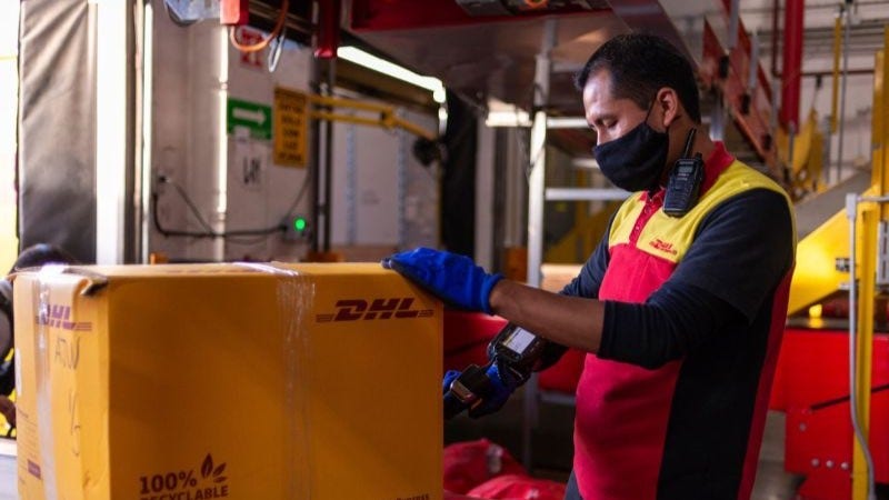DHL Express staff helping to ship electronics to India