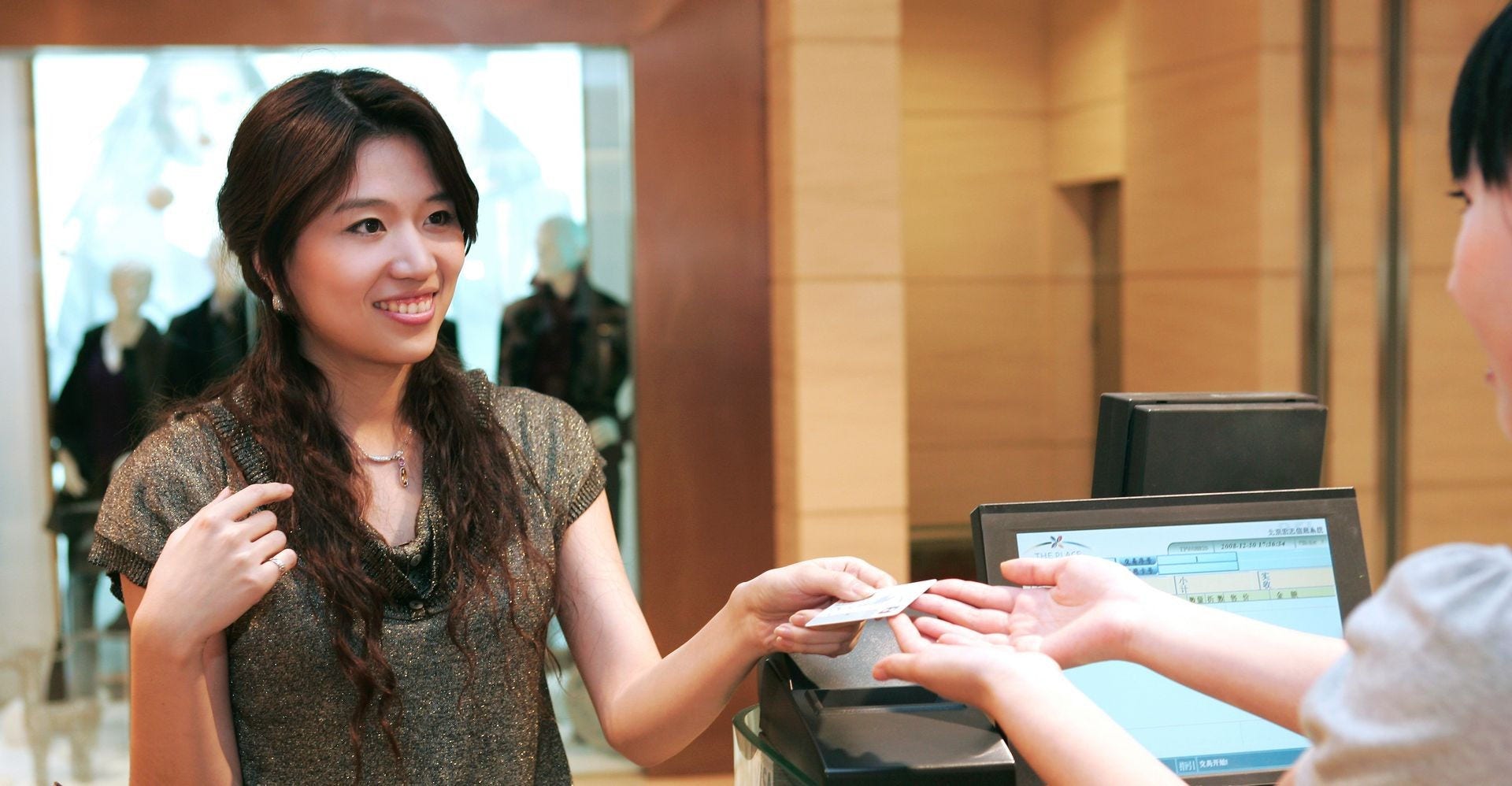 female customer making digital payment for her purchase