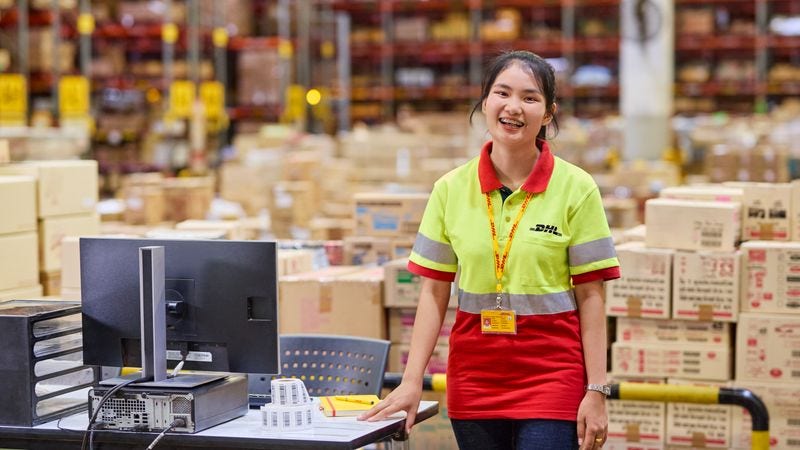 DHL Express employee assisting with warehouse operations in Cambodia