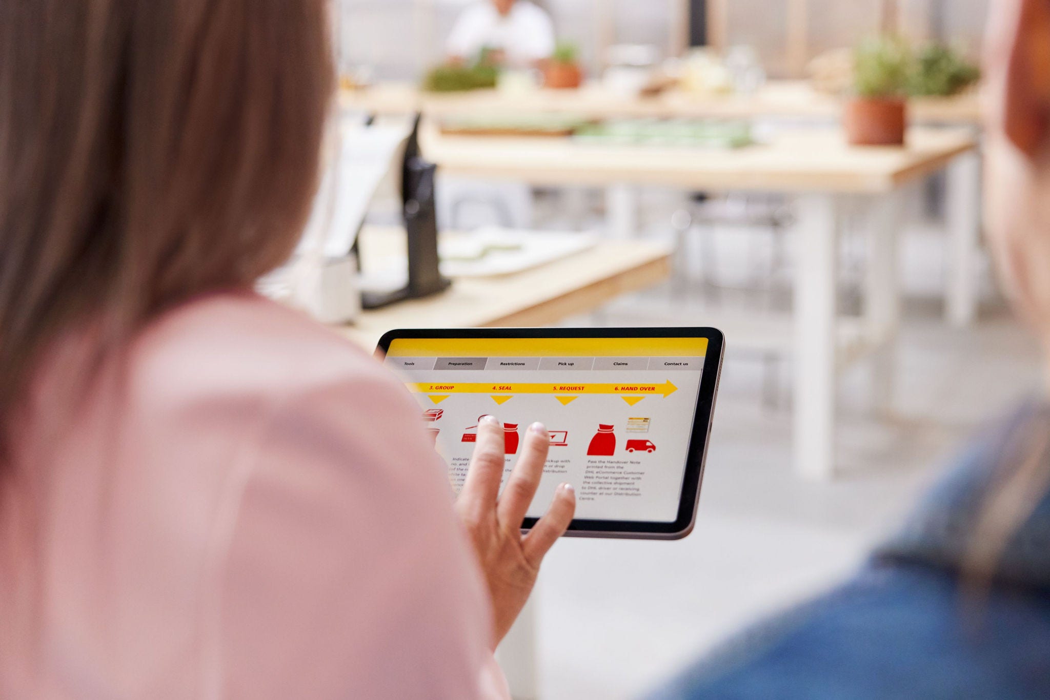 a business owner using dhl tools to calculate international shipping costs