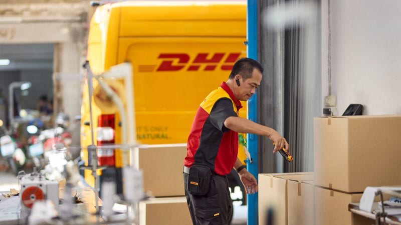 dhl express employee scanning packages for on-demand delivery