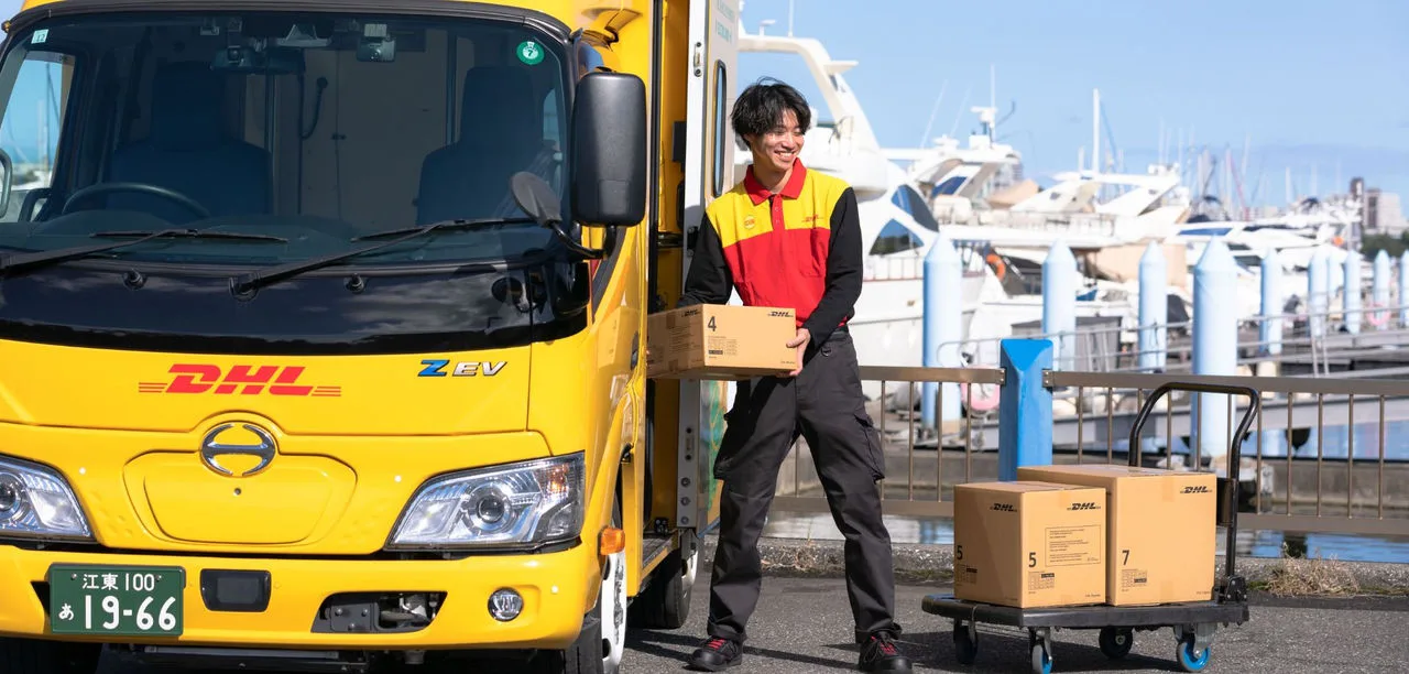 dhl courier handling packages at harbor