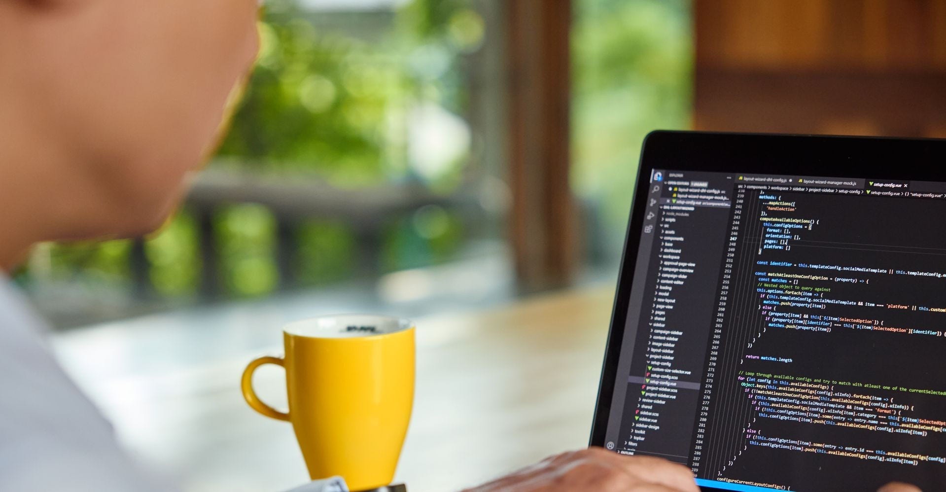 a male dhl employee writing codes on a laptop