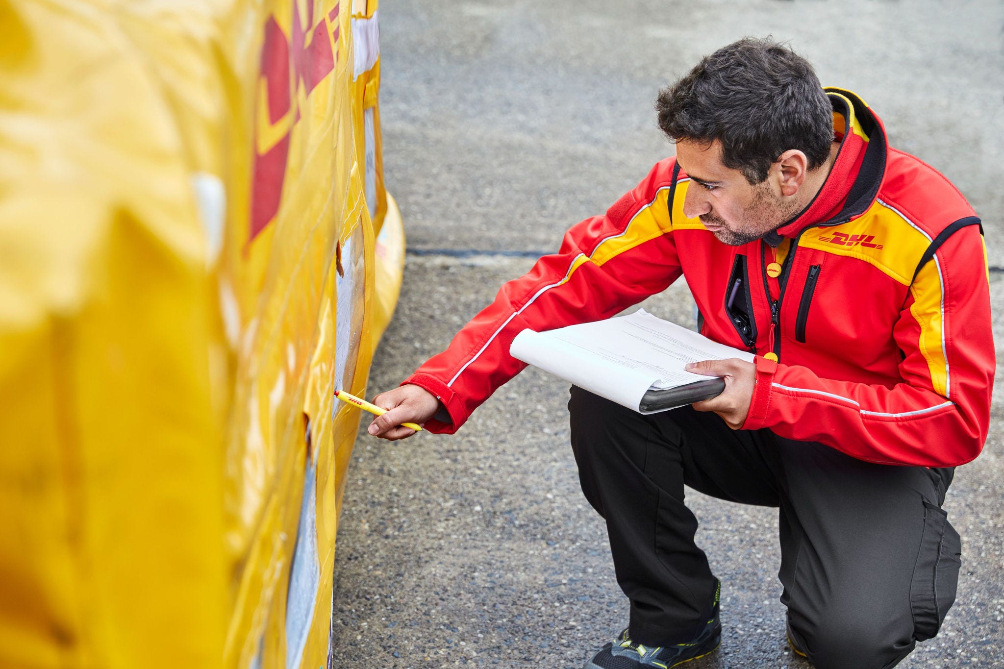 dhl staff inspecting consolidated shipment