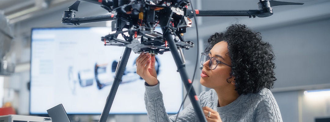 woman fixing a robot