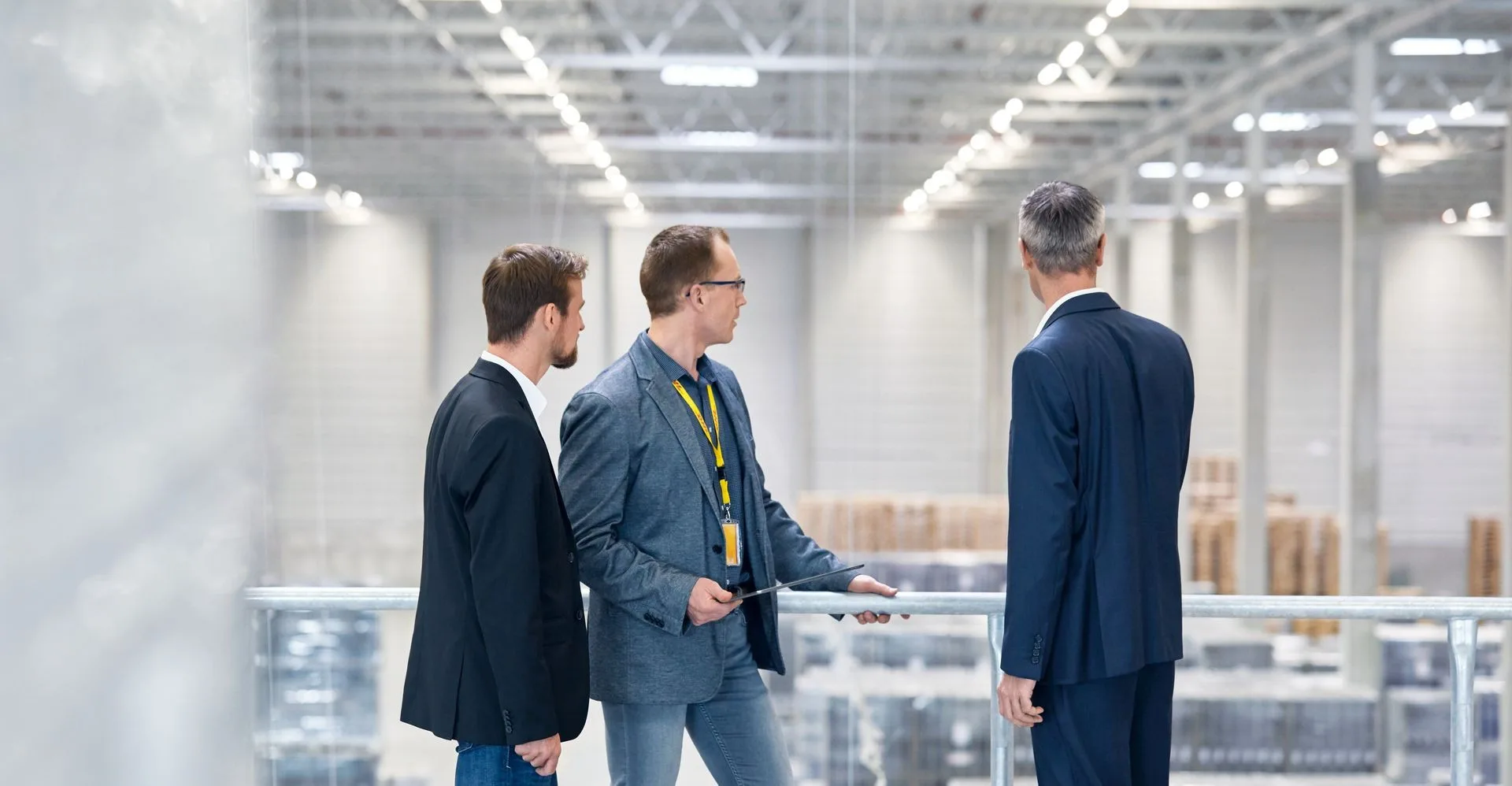 businessmen overlooking their production line