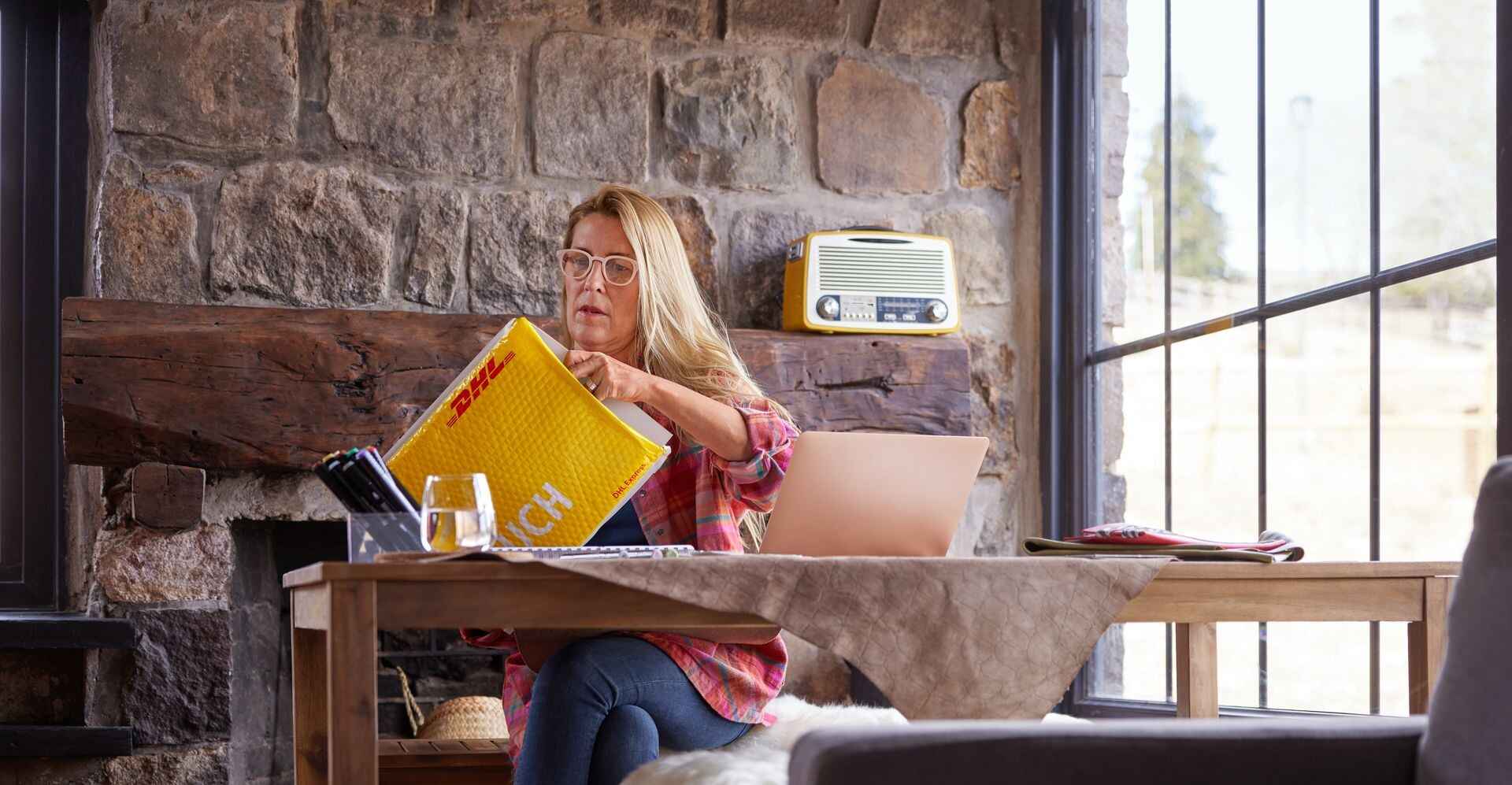  一位女士正在打開一個從台灣寄往美國的包裹