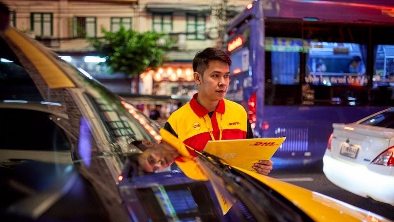DHL Express employee doing a passport delivery at night