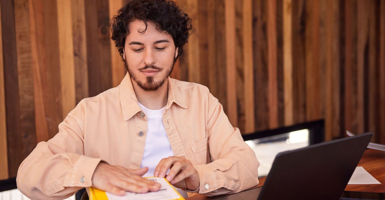 business owner pasting waybill on dhl express parcel