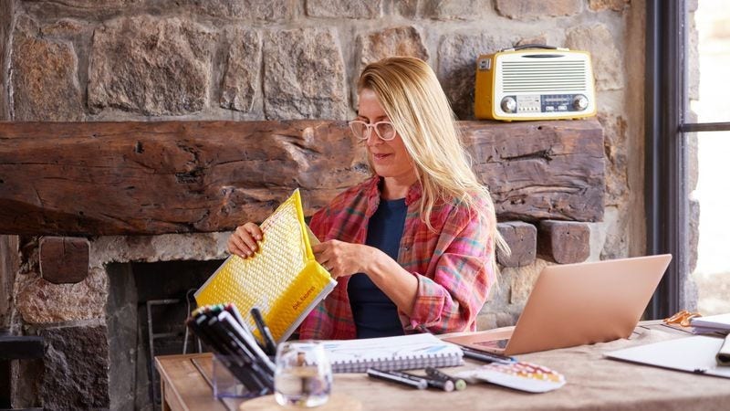 Smiling customer receiving an express parcel from DHL Express NZ