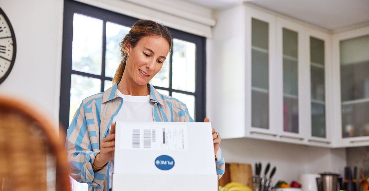 woman unboxing a parcel during Peak Season 