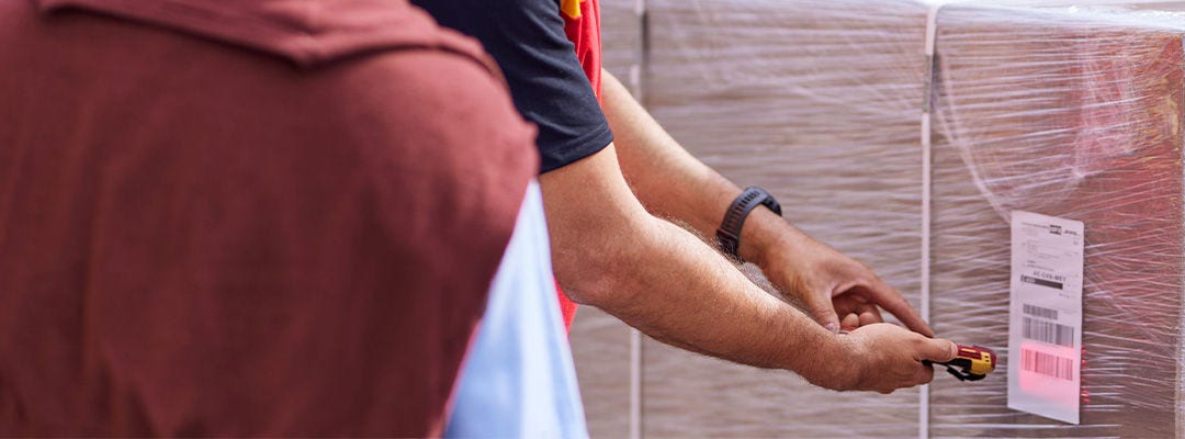 DHL employee scanning pallet