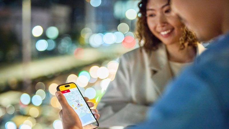 Male and female customer tracking their biological sample shipping status via smartphone