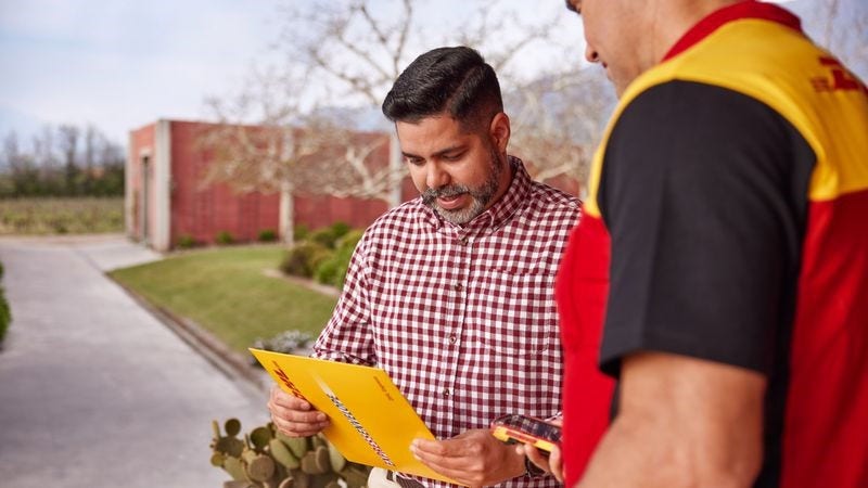 person receiving international document shipping from dhl express employee