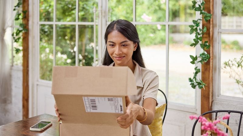 Lady opening a dropshipping package 