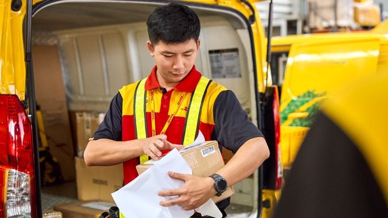 DHL Express employee attaches a shipping label to a parcel containing traditional Sri Lankan jewellery.