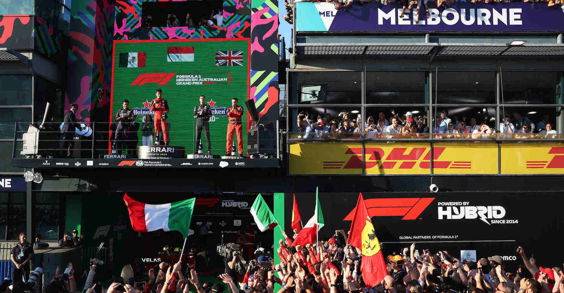 MELBOURNE GRAND PRIX CIRCUIT, AUSTRALIA - APRIL 10: Sergio Perez, Red Bull Racing, 2nd position, Charles Leclerc, Ferrari, 1st position, George Russell, Mercedes-AMG, 3rd position, and the Ferrari trophy delegate on the podium during the Australian GP at Melbourne Grand Prix Circuit on Sunday April 10, 2022 in Melbourne, Australia. (Photo by Glenn Dunbar / Motorsport Images / Adrivo)