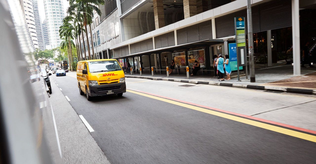 dhl courier charging his electric vehicle