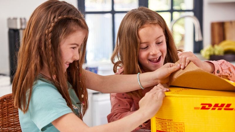 two girls opening a subscription box delivered by dhl express
