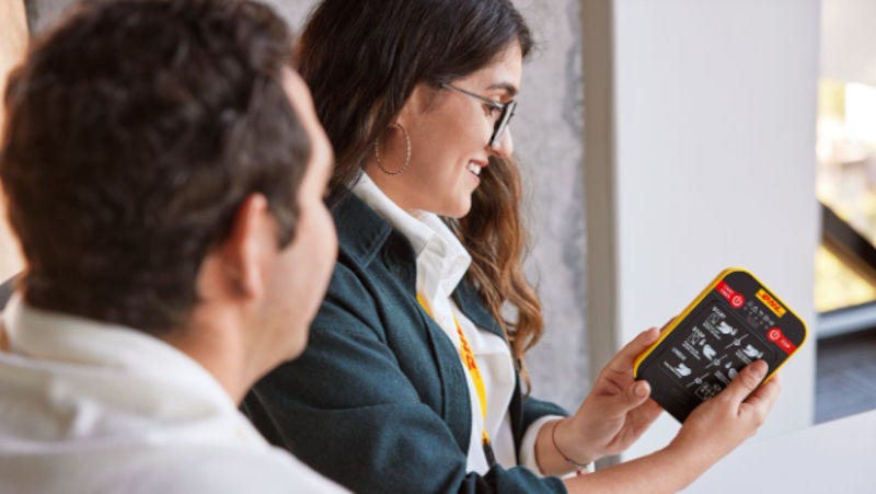 dhl express staff going through shipping tools with a customer