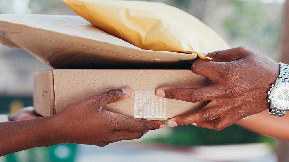 courier passing parcel to recipient