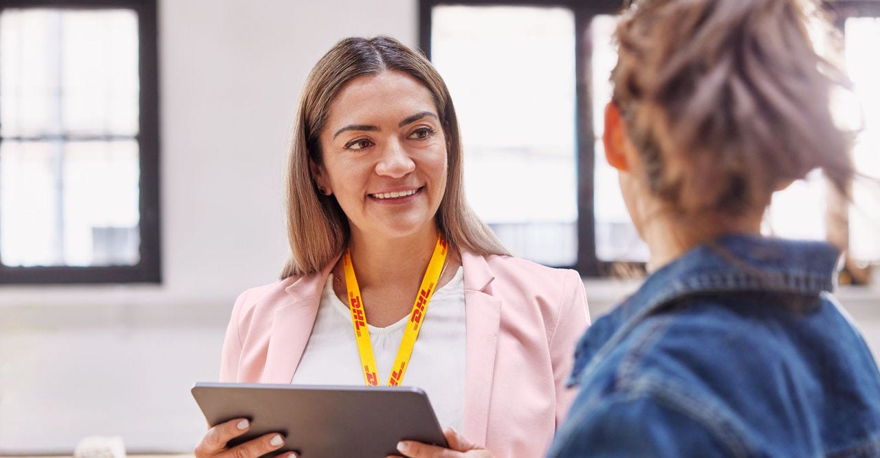 a dhl employee talking to a business owner