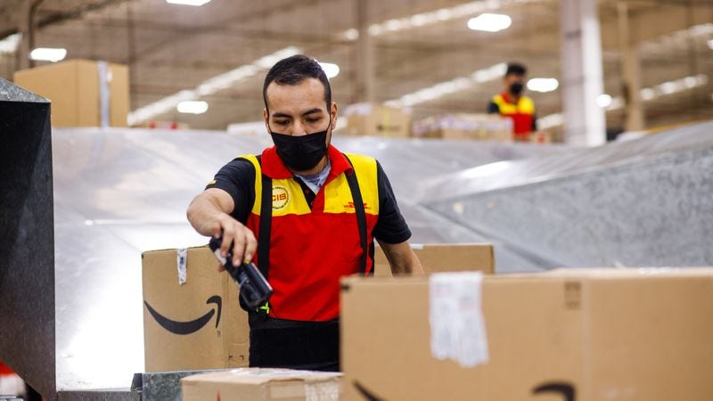 dhl express staff scanning a parcel