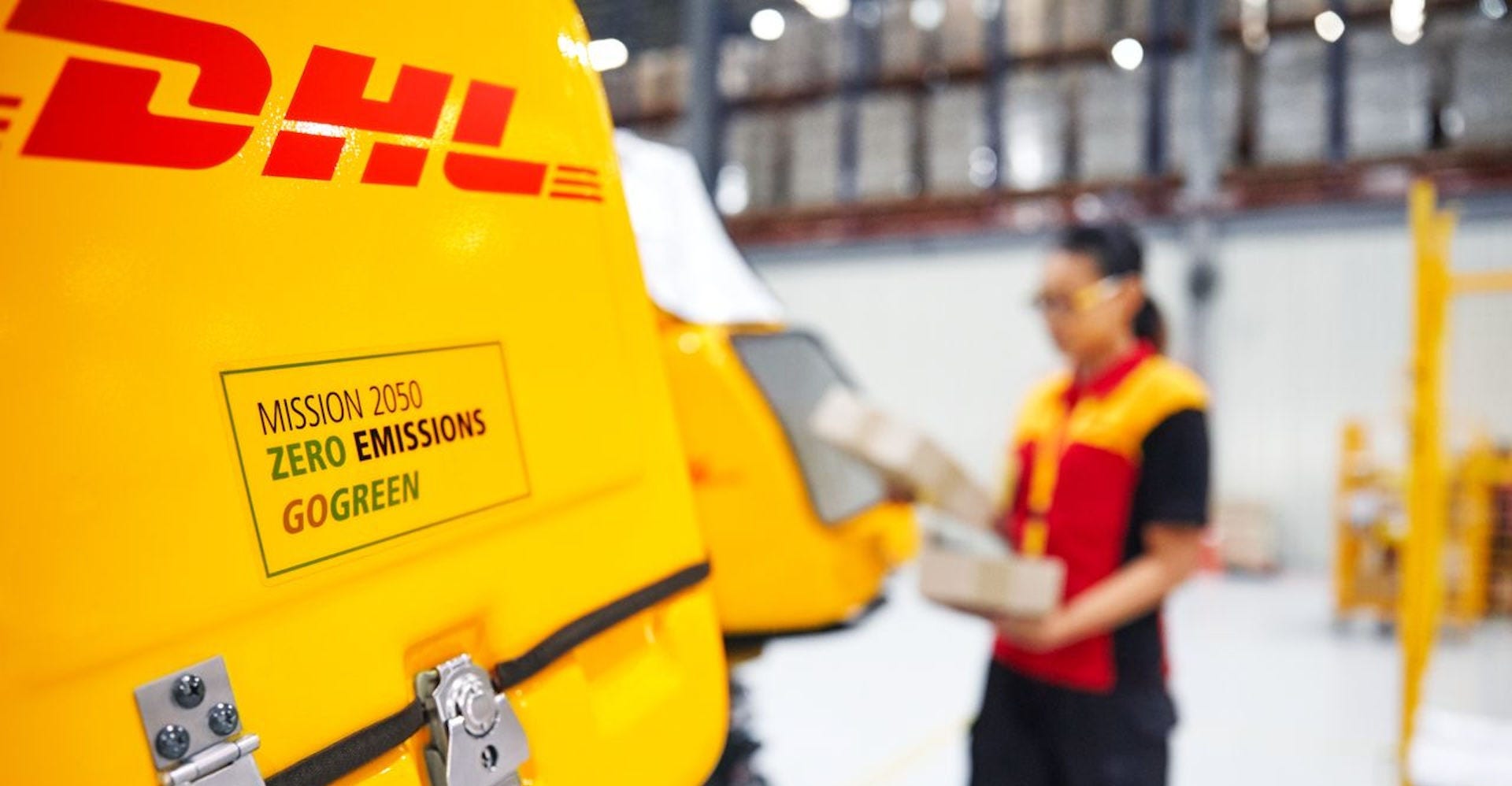 close up of dhl courier scooter with dhl gogreen green logistics information