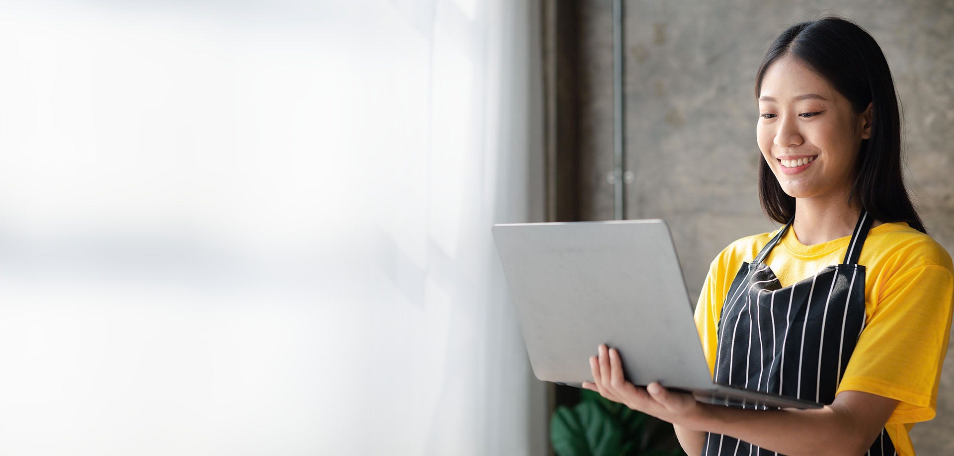 woman smiling at laptop screen