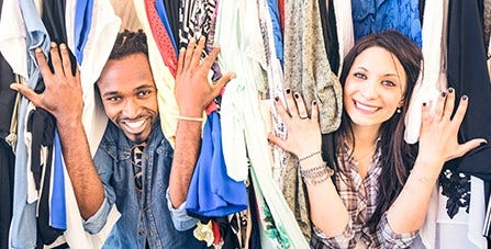 man and woman poking through clothes
