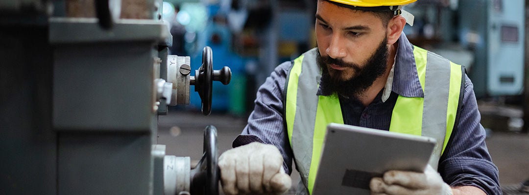 man in hi vis working on a machine