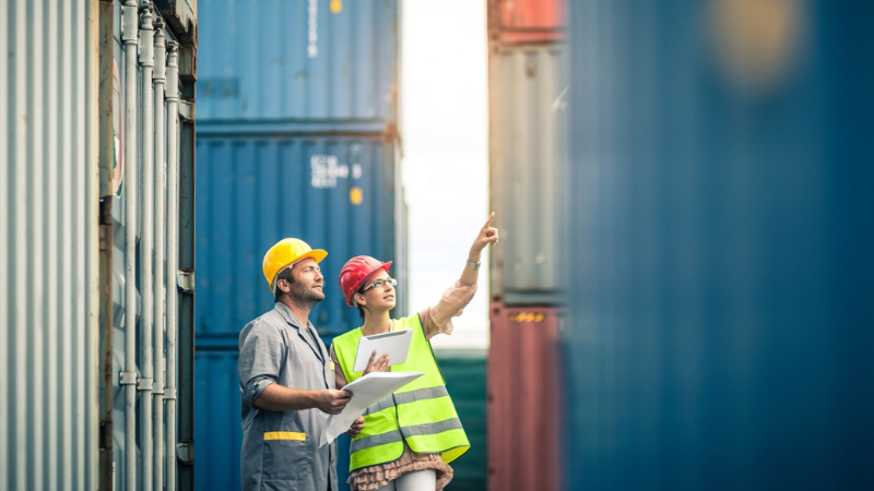international logistics workers among containers